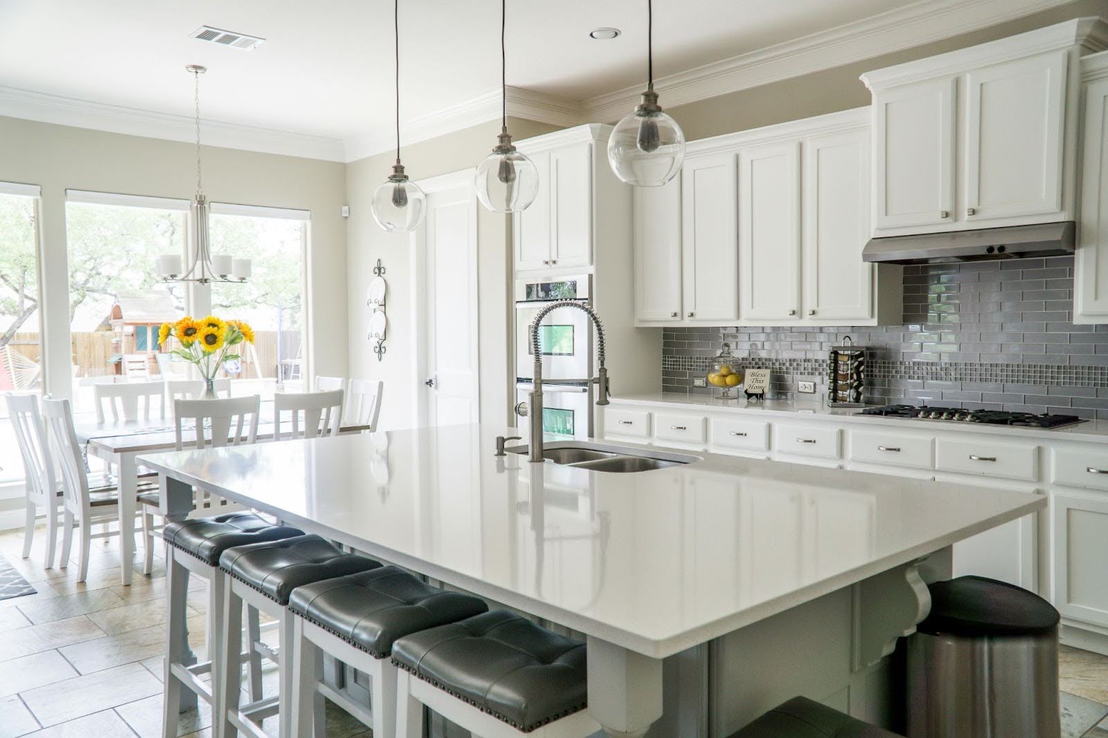Newly renovated kitchen with white appliances and ample dayligh